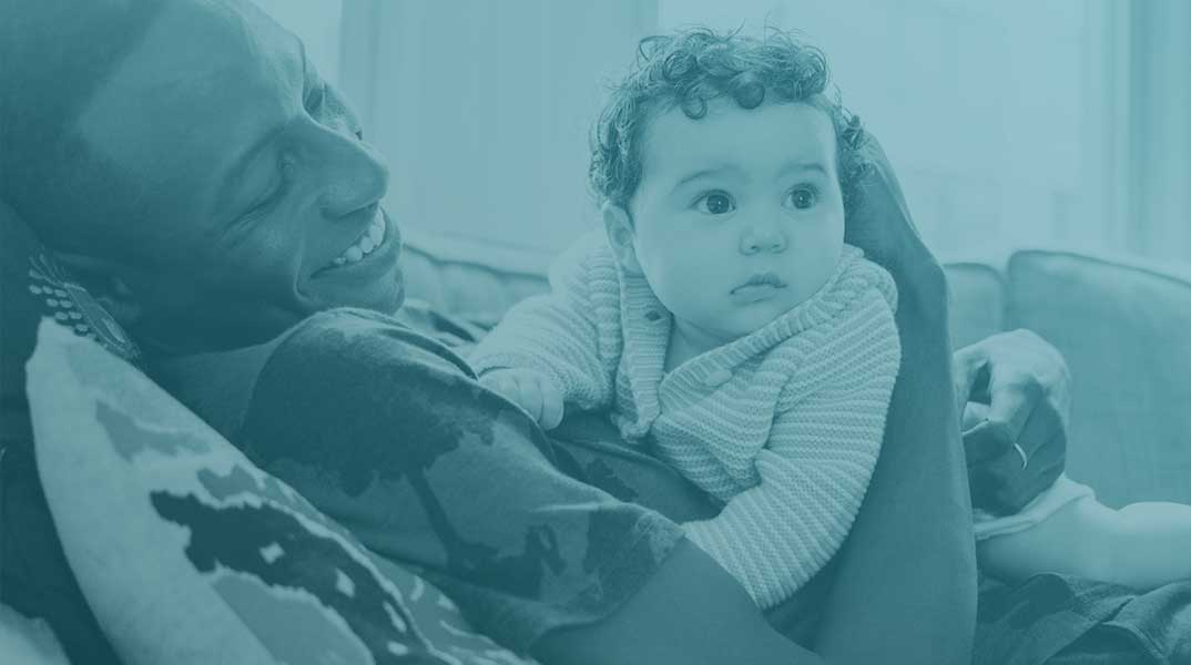 reclined man smiling at baby